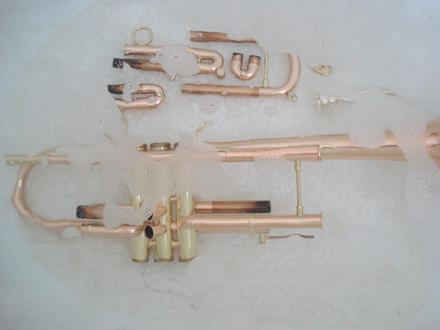 soaking a trumpet for cleaning